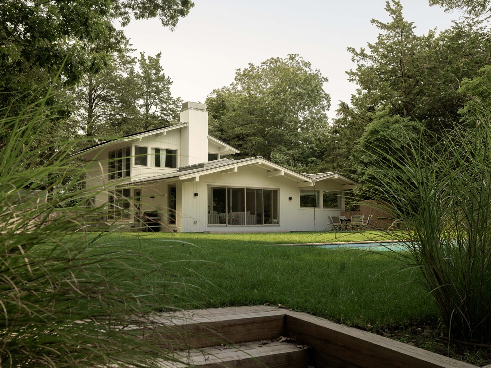 A new metal roof and vertical wood siding reference the classic architecture of the Hamptons.